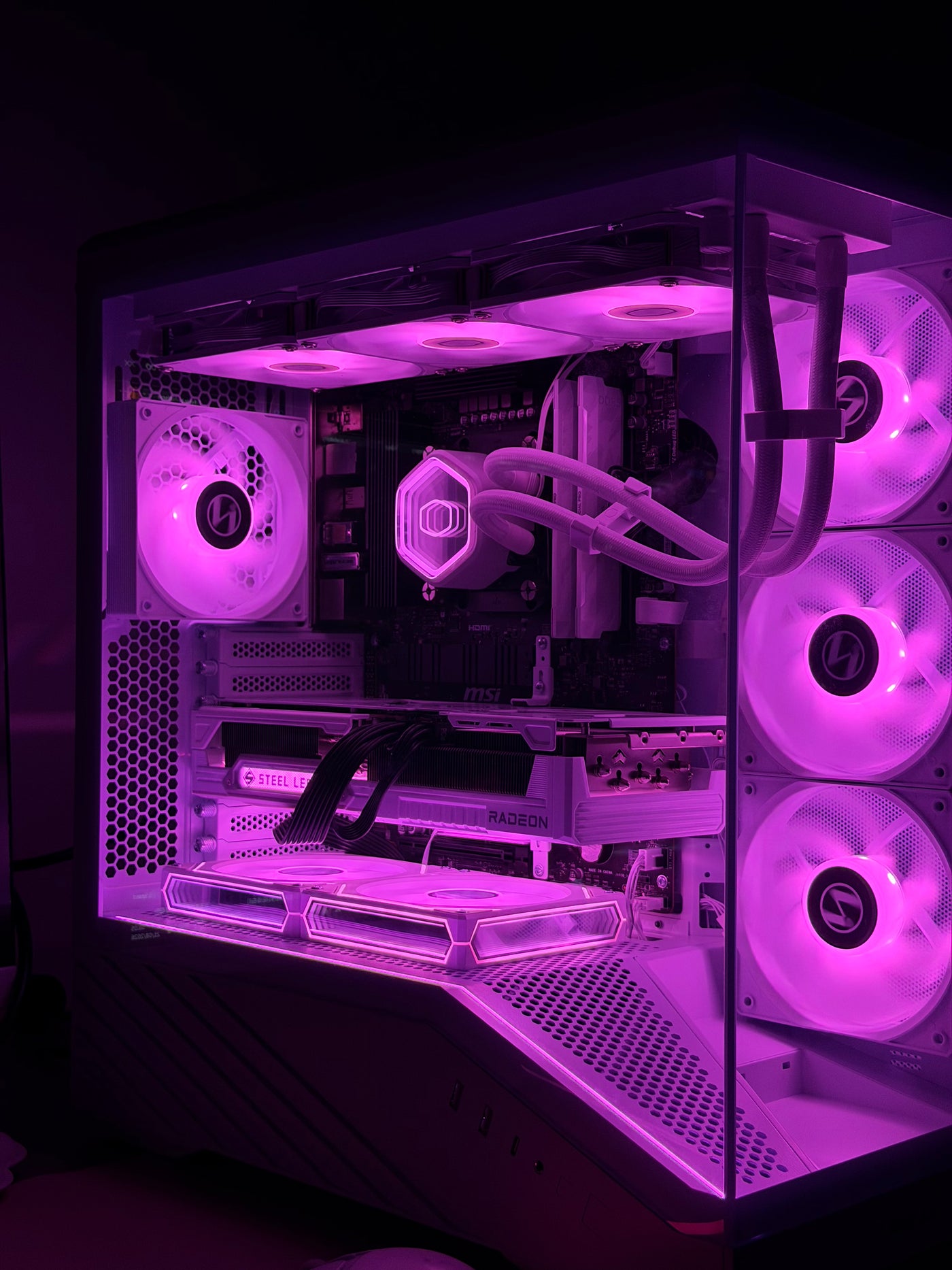 Titan PC with a glass case, liquid cooling and purple-lit components.